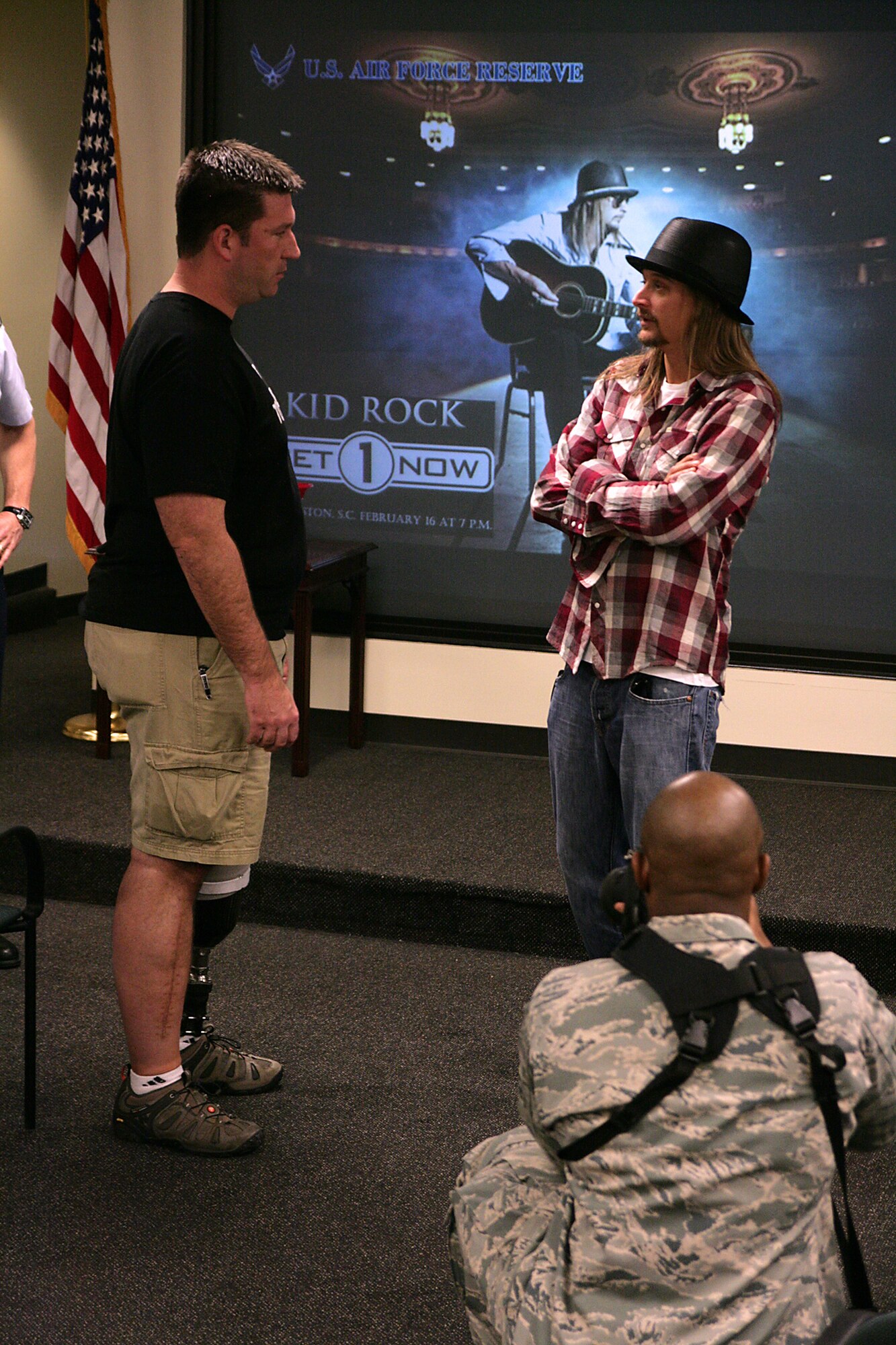 Tech. Sgt. Mike Williams, 628th Civil Engineering Squadron explosive ordinance disposal technician, discusses his war injuries from Afghanistan with Kid Rock during the performers visit to the 315th Airlift Wing Feb. 16, 2011. (USAF photo/Michael Dukes)