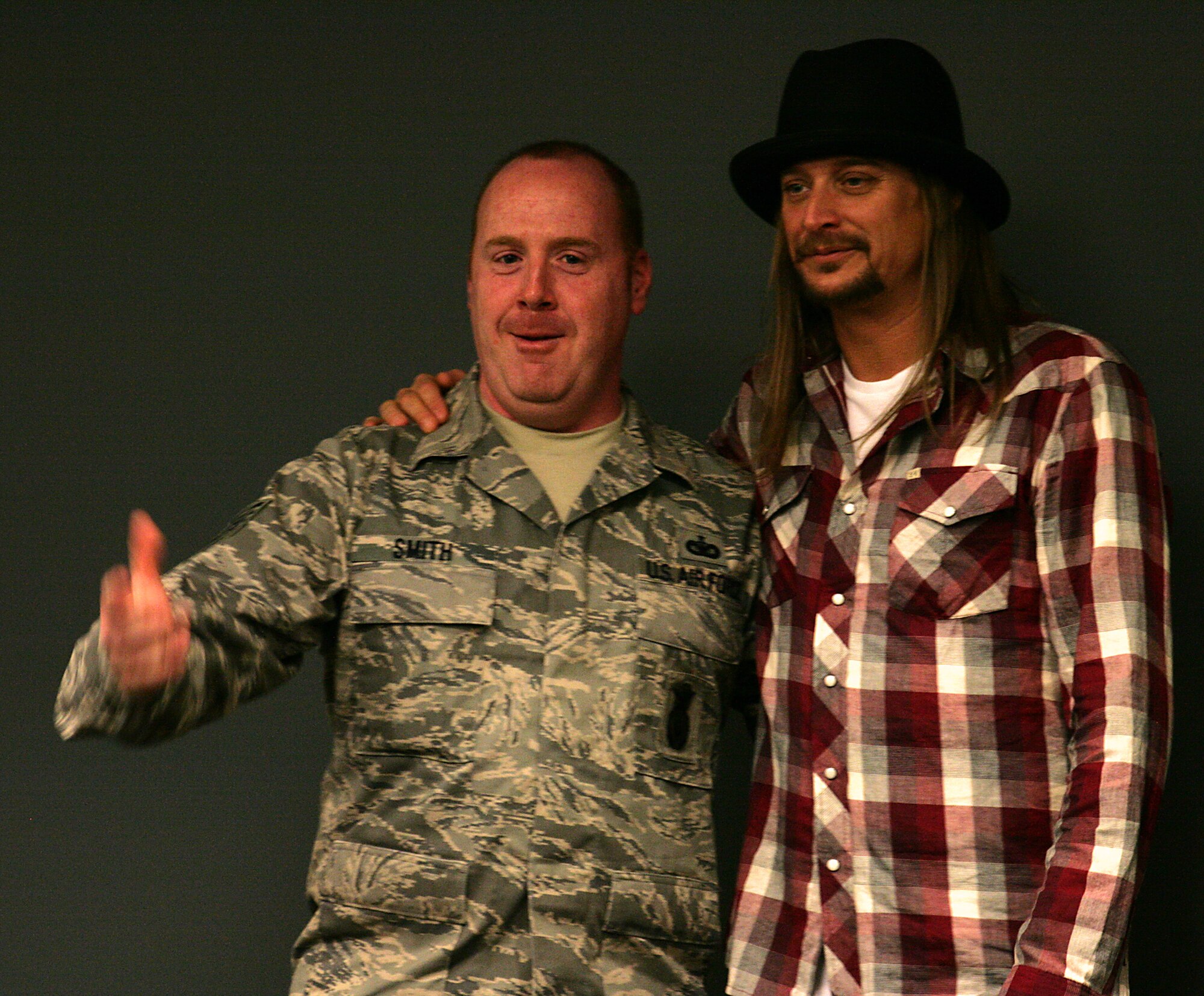Tech. Sgt. Steven Smith, 315th Security Forces Squadron, posses for a photo with Kid Rock during the performer's visit to the 315th Airlift Wing on Feb. 16, 2011. (USAF Photo/Michael Dukes)