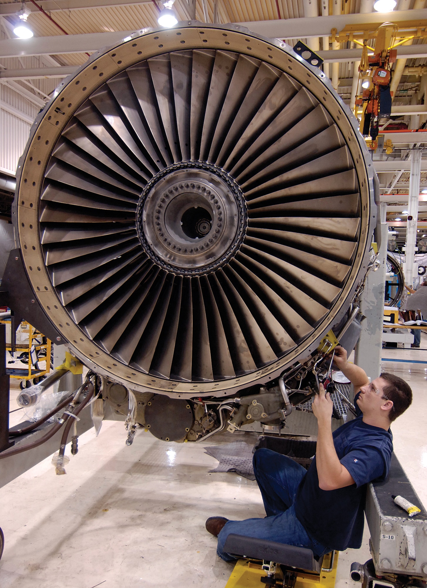 Chris Clark assembles an F108 engine in their new Bldg. 9001 area.  Workers began their move-in Dec. 5 and finished just nine days later, relying on all the shifts who still produced engines for the KC-135R during their relocation. (Air Force photos by Margo Wright)