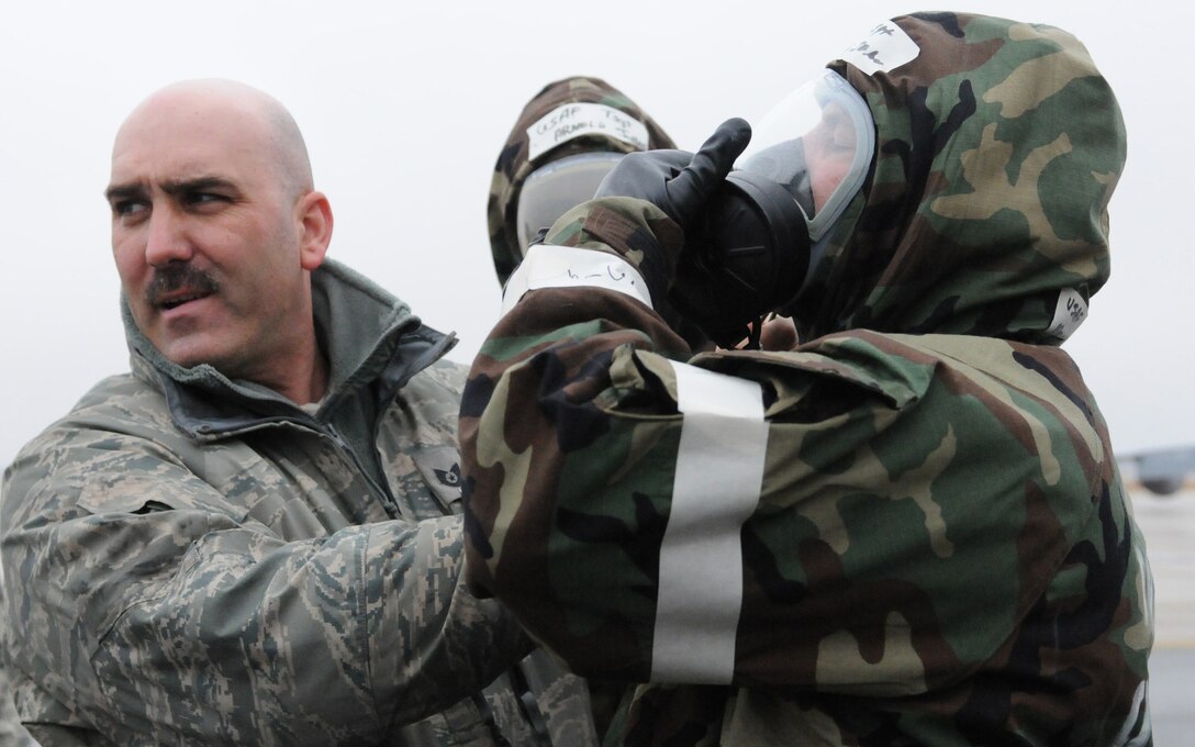 JOINT BASE ANDREWS, Md. -- Tech. Sgt. Chris McAlister, 459th Aircraft Maintenance Squadron Exercise and Evaluation Team member, shows 459th Air Refueling Wing Airmen how to ensure there is an airtight seal on their gas masks during a mobility and readiness exercise Feb. 5 here. Along with knowing the proper wear of gas masks, 459 ARW Reservists also trained in other scenarios like understanding alarm signals and donning Chemical Protective Overgarments during exercise Vantage Rally/Tiger Claw 11-01. The three-day exercise prepared the wing for an upcoming Operational Readiness Inspection scheduled for 2012. (U.S. Air Force photo/Tech. Sgt. Steve Lewis)