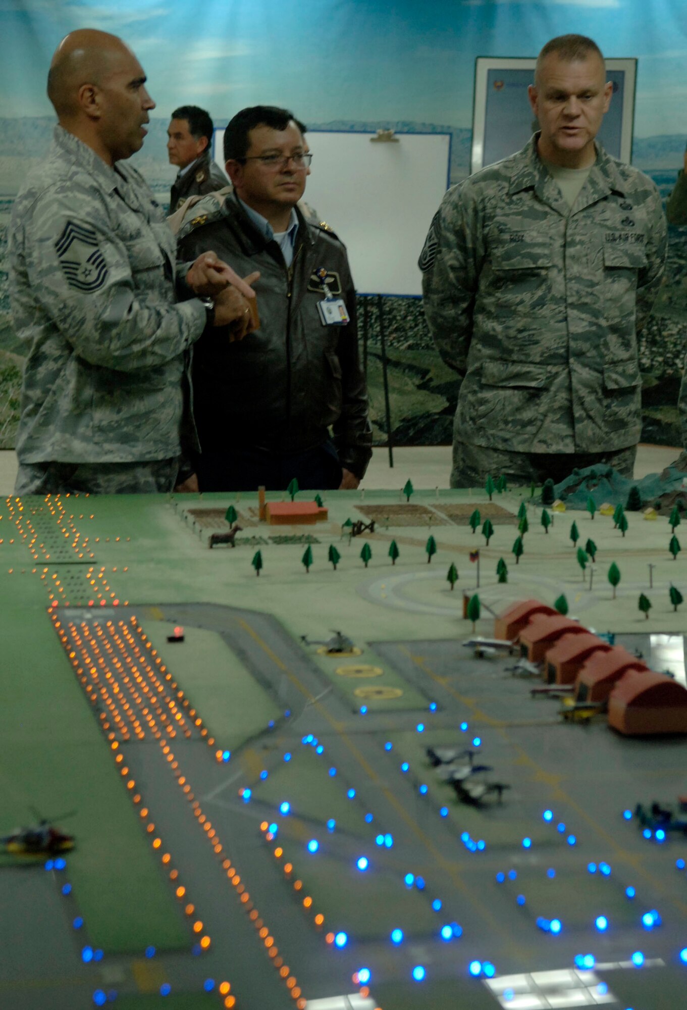 BOGOTA, Colombia -- Chief Master Sgt. Andres Alvarez (left), Inter-American
Air Force Academy command chief, translates for Chief Master Sgt. of the Air
Force James Roy (right) during a discussion with Col. Cano, commander of the
Colombian Air Force Escuela de Suboficiales Feb. 1. The Escuela de
Suboficiales is a three-year NCO academy which grants undergraduate degrees
in military specialties to more than 100 students a year. Chief Roy's visit focused on strengthening relationships between U.S. and Columbian Airmen. (U.S. Air Force photo/Tech. Sgt. Eric Petosky)
