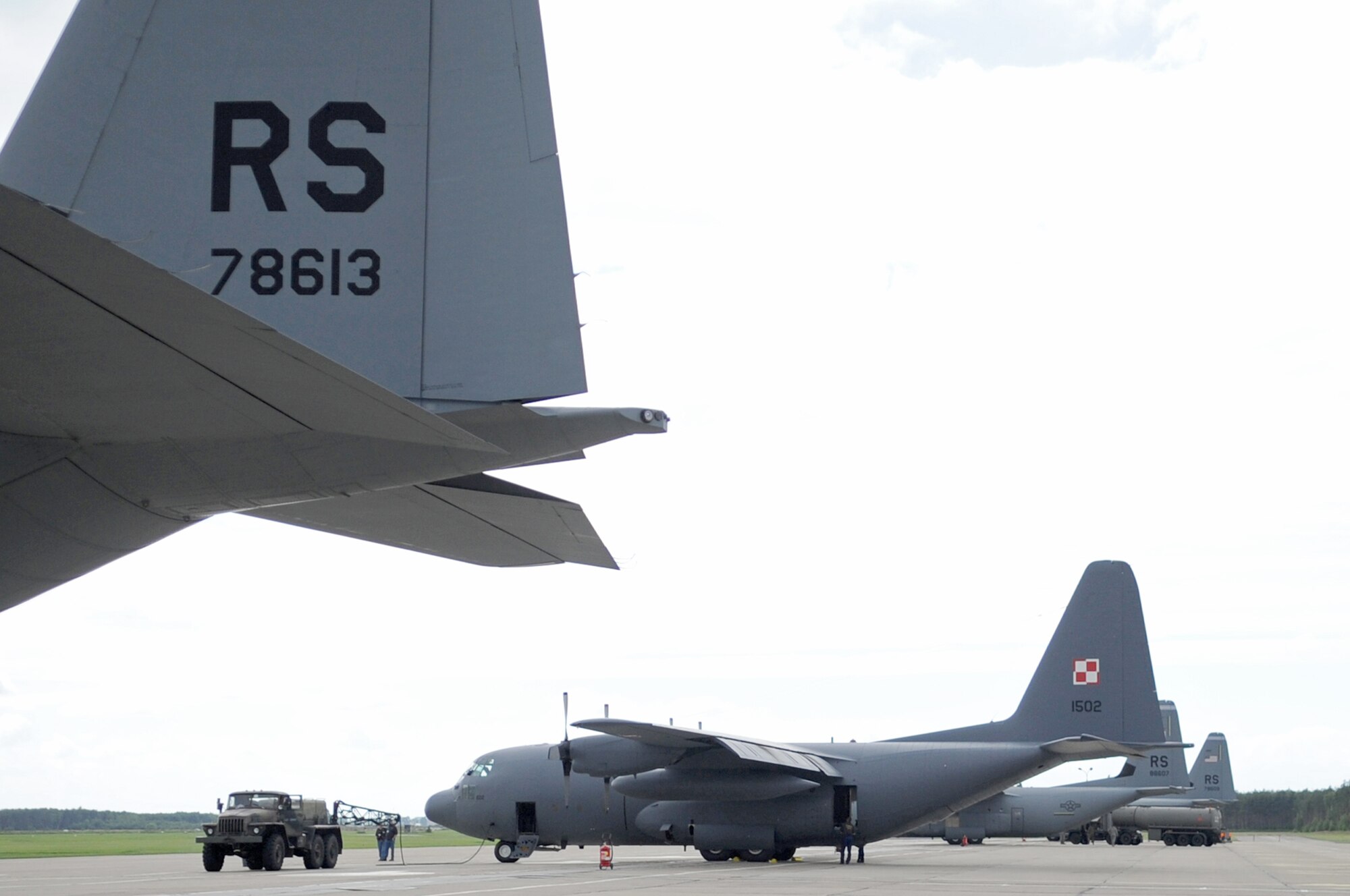 A C-130J and a Poland air force C-130E park on the flightline during a visit June 21, 2010, to Powidz Air Base, Poland. (U.S. Air Force photo/Airman 1st Class Grovert Fuentes-Contreras)