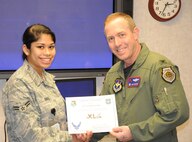 LAUGHLIN AIR FORCE BASE, Texas – Col. Michael Frankel, 47th Flying Training Wing commander, presents Airman 1st Class Olivia Oteo, 47th Medical Operations Squadron, with the XLer of the Week award Feb. 16. The XLer is a weekly award chosen by wing leadership and given to those who consistently make outstanding contributions to Laughlin and their unit. (U.S. Air Force photo by Airman 1st Class Blake Mize)
