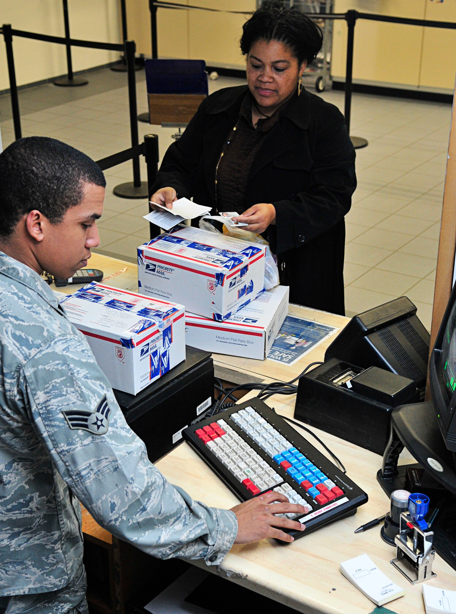 U.S. Air Force Senior Airman Oluchi Garnica, 86th Communications Squadron postal clerk, assists a customer mailing a parcel at the Northside Post Office, Ramstein Air Base, Germany, Feb. 17, 2011. Parcel pick-up is Monday through Friday 10 a.m. - 5:30 p.m., Saturday 10 a.m. – 1 p.m. and closed on Sunday. (U.S. Air Force photo by Airman 1st Class Desiree Esposito)