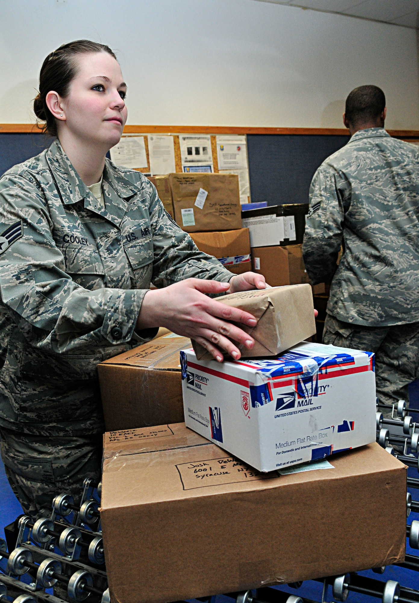 U.S. Air Force Senior Airman Mindi Cooley, 86th Communications Squadron postal clerk, organizes parcels for mailing at the Northside Post Office, Ramstein Air Base, Germany, Feb. 17, 2011. Parcel pick-up is Monday through Friday 10 a.m. - 5:30 p.m., Saturday 10 a.m. - 1 p.m. and closed on Sunday. (U.S. Air Force photo by Airman 1st Class Desiree Esposito)