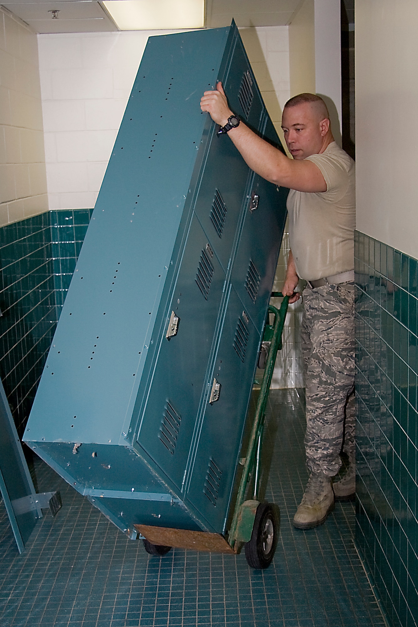 GRISSOM AIR RESERVE BASE, Ind. -- Airman 1st Class David Kessen, 434th Civil Engineer Squadron engineer apprentice, removes old lockers from the base fitness center here Feb. 14. New wooden lockers were recently installed, which provide double the storage space to the user and replaced metal lockers that were originally installed when the facility was a child development center. (U.S. Air Force photo/Tech. Sgt. Mark R. W. Orders-Woempner) 
