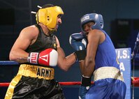 U.S. Army Staff Sgt. Charles Blackwell, Tucson, Ariz., stops Marine Lance Cpl. Norman Watford, Camp Lejeune, N.C., Feb. 15 during the second round of their Armed Forces Boxing Championships bout Tuesday at Lackland Air Force Base, Texas.  (U.S. Air Force photo/Robbin Cresswell)