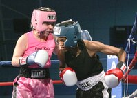 Fast Katz's Patricia Cuevas (civilian/pink trunks) was behind on points but clawed her way back to defeat U.S. Navy Master at Arms Rhonda McGee, Whidbey Island Naval Air Station, 14-13, Feb. 15 during the Armed Forces Boxing Championships at Lackland Air Force Base, Texas. (U.S. Air Force photo/Robbin Cresswell)