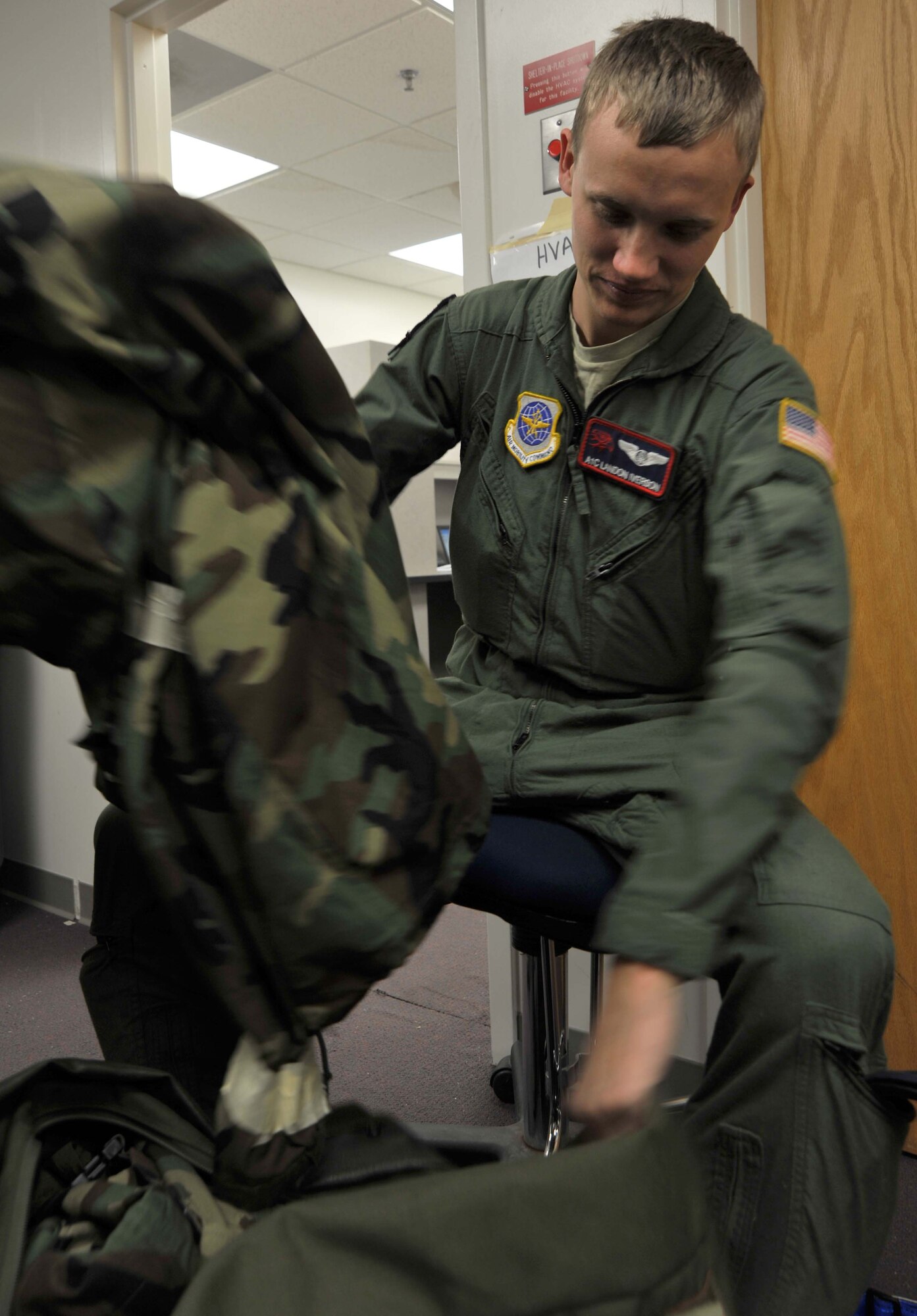 Airman 1st Class Landon Iverson, 350th Air Refueling Squadron boom operator, packs his Mission Oriented Protection Posture gear after participating in a readiness exercise Feb. 16, 2011, McConnell Air Force Base, Kan.  As a boom operator, the Weatherford, Texas, native inspects, operates and troubleshoots in-flight refueling systems.  (U.S. Air Force photo/Senior Airman Abigail Klein)