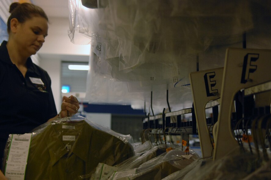 Michelle Todd, Barksdale Cleaners front counter assistant, pulls a freshly cleaned uniform for a customer on Barksdale Air Force Base, La. Feb. 17. The Barksdale Cleaners is located inside the base exchange. (U.S. Air Force photo/Senior Airman Allison M. Boehm)(RELEASED)