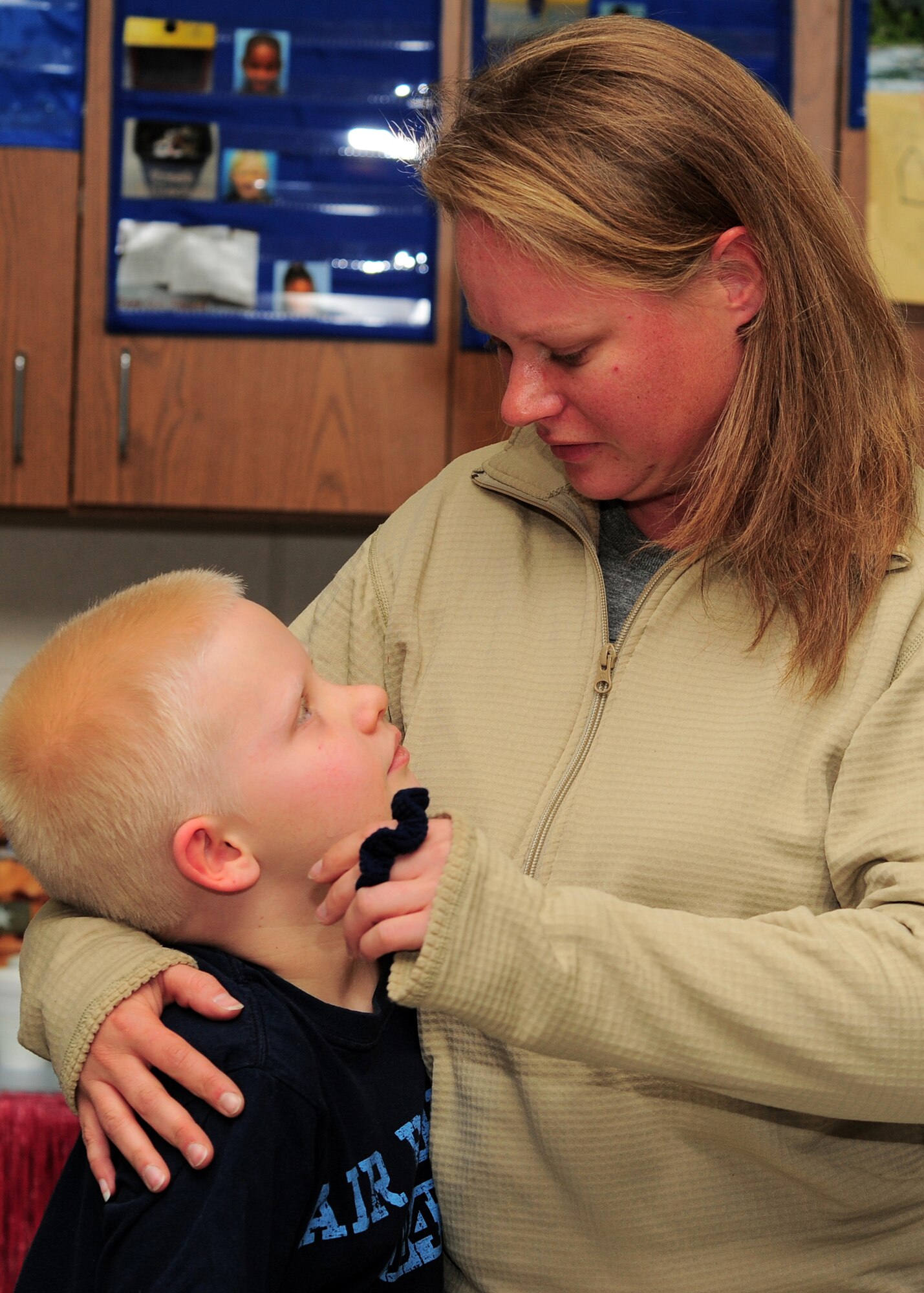 SHAW AIR FORCE BASE, S.C. -- Technical Sgt. Audrey Gippe, 20th Logistics Readiness Squadron, holds her son Tyler, age 7, after surprising him at his school Feb. 16, 2011. Sergeant Gippe recently arrived back from her deployment after a mortar round went off beside her. Her husband, Tech. Sgt. Christopher Gippe, 20th Emergency Maintenance Squadron, planned the visit to the school to surprise their kids as they didn't know their mom was back. (U.S. Air Force/Airman 1st Class Daniel Phelps(Released)) 