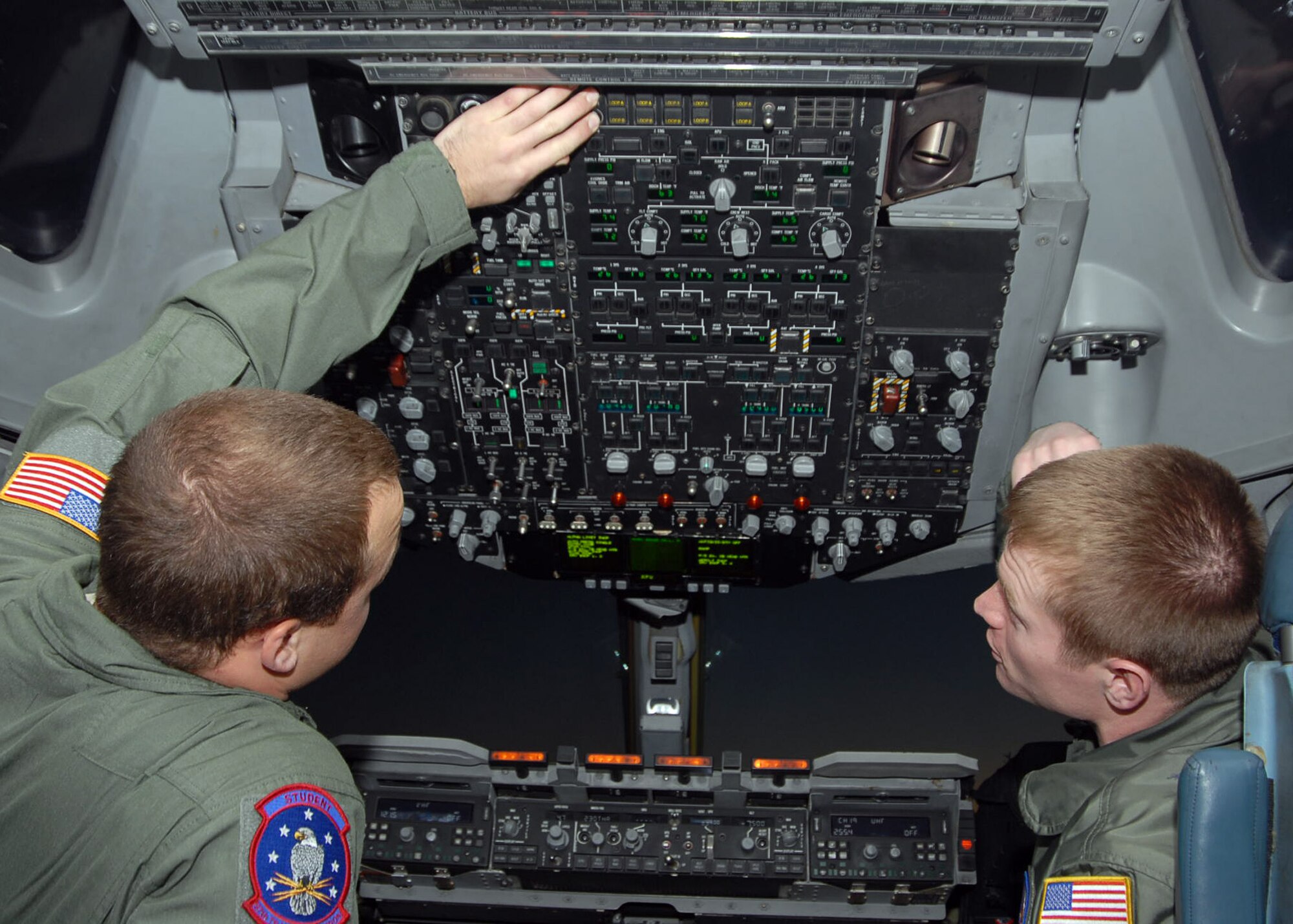 ALTUS AIR FORCE BASE, Okla. – Airman 1st Class Stephen Greer (left), a C-17 Globemaster III loadmaster student, performs an interior safety inspection in a C-17 cockpit Feb. 11. Staff Sgt. Christopher Massey (right), 58th Airlift Squadron C-17 loadmaster instructor, serves as Airman Greer’s trainer during his night vision goggle flight, which is one of the last flights of the loadmaster initial qualification course. Stephen, along with his brother Michael Greer, joined the Air National Guard prior to attending University of Mississippi on a track and field scholarship for pole vaulting. The Greer brothers are from Clinton, Miss. (U.S. Air Force photo by Staff Sgt. Clinton Atkins 97th Air Mobility Wing)