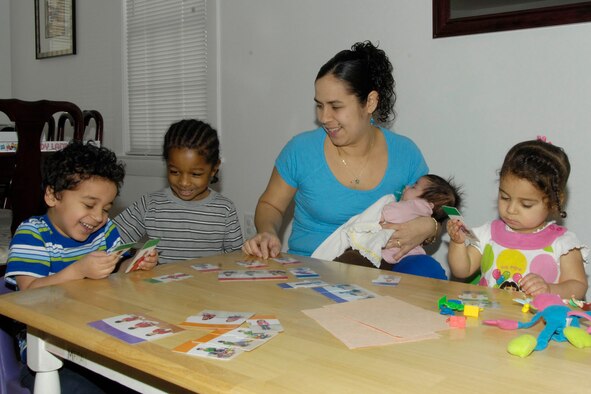 HANSCOM AIR FORCE BASE, Mass. - Leonor Ayala (middle) participates in activities with Markos Ayala, Justin Chapman, Kiara Ayala and Alondra Ayala at her home on Feb. 16. After a two year process, Ms. Ayala recently learned she received accreditation from the National Association for Family Child Care, becoming Hanscom’s fourth provider to earn the honor. (U.S. Air Force photo by Linda LaBonte Britt)