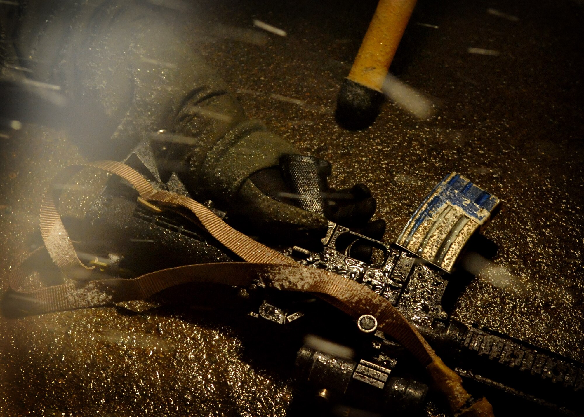 A simulated casualty holds their weapon during Operational Readiness Exercise Beverly Midnight 11-01 at Osan Air Base, Republic of Korea Feb. 17.  The exercise allows Airmen to demonstrate their ability to complete the mission in simulated chemical environments while executing their primary duties, practicing self aid and buddy care, conduction post-attack reconnaissance and unexploded ordnance sweeps. (U.S. Air Force Photo/Senior Airman Evelyn Chavez)