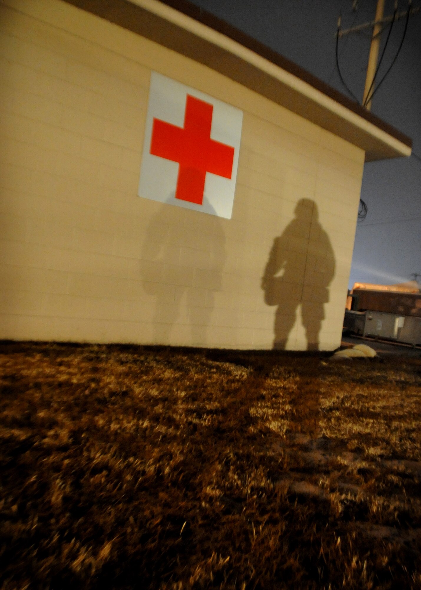 A shadow of an Airman is cast on a wall during Operational Readiness Exercise Beverly Midnight 11-01 at Osan Air Base, Republic of Korea Feb. 17.  The exercise allows Airmen to demonstrate their ability to complete the mission in simulated chemical environments while executing their primary duties, practicing self aid and buddy care, conduction post-attack reconnaissance and unexploded ordnance sweeps. (U.S. Air Force Photo/Senior Airman Evelyn Chavez)