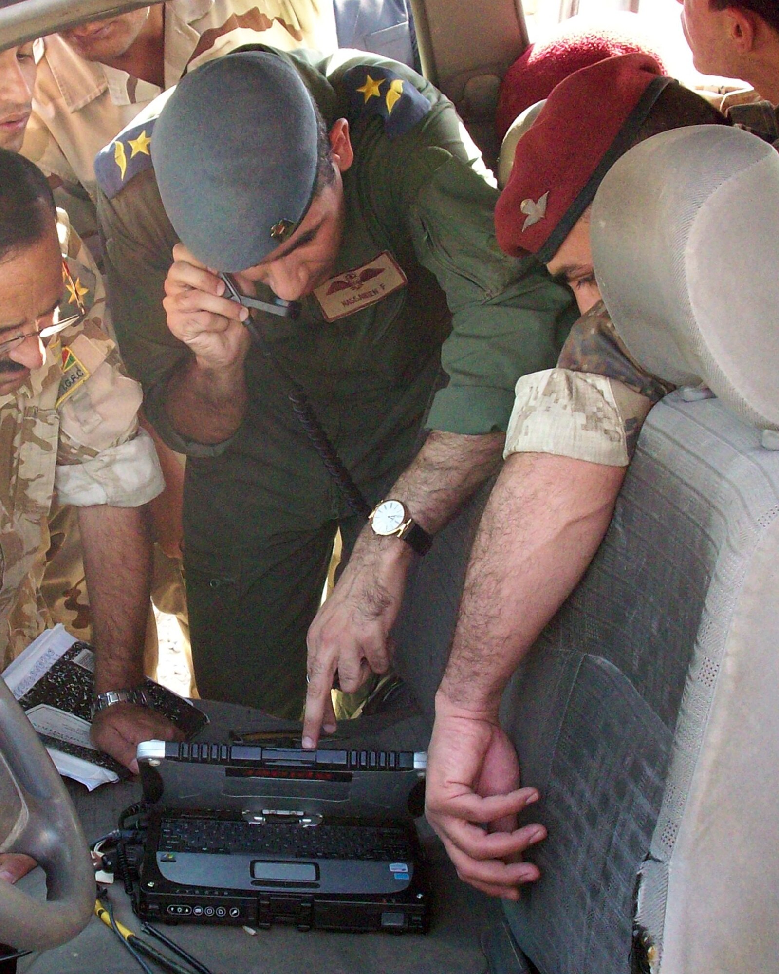 ALI AIR BASE, Iraq -- Iraqi airmen and soldiers communicate with an airborne King Air 350, controlling and directing airborne sensors through the "Spider" mobile ground station during a Joint Air Operations Integration Team exercise.  The JAOIT is training different branches of the Iraqi military how to work together seamlessly. (Courtesy Photo)
