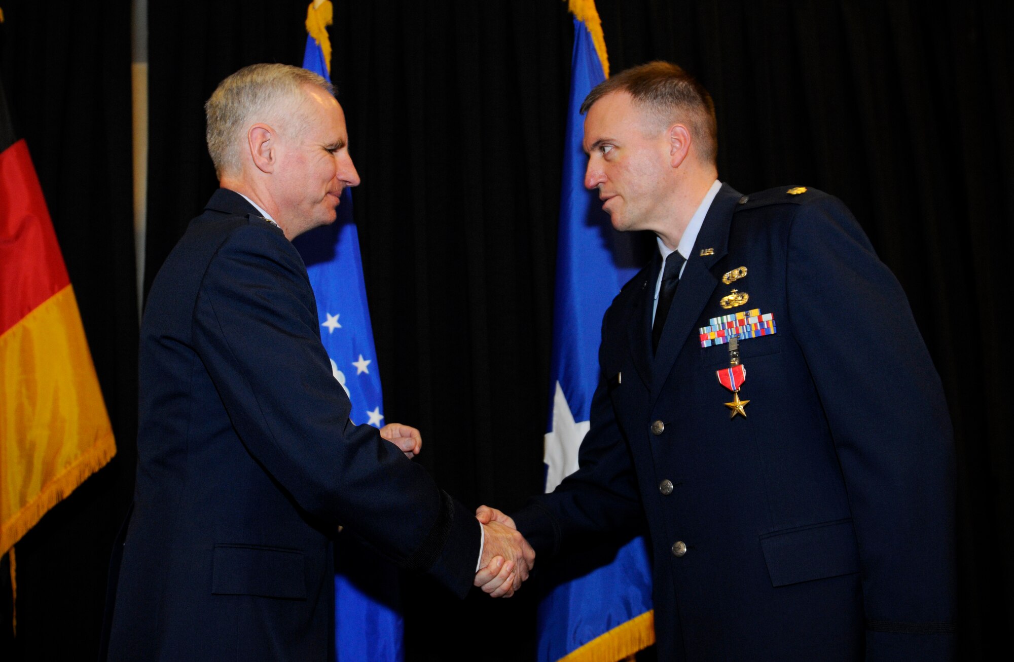Maj. Gen. Mark Schissler, U.S. Air Forces in Europe director of the Plans, Programs and Analyses Directorate, presents the Bronze Star to Maj. Robert Firman, USAFE Directorate of Plans, Programs and Analyses executive officer, Feb. 14, 2011, at Ramstein Air Base, Germany. Major Firman was deployed as the Regional Support Command-Capital commander, NATO Training Mission - Afghanistan and Combined Security Transition Command ? Afghanistan, from Feb. 28 to Aug. 28, 2010. While filling a billet normally reserved for an Army Combat Arms colonel, Major Firman led 138 combat operations throughout Kabul Province. He developed and implemented the Kabul Security Plan, partnering with the Afghan Ministry of Defense and Ministry of Interior to plan and execute the fastest growth phase for the Afghan National Security Forces since its inception. The Bronze Star is awarded to a person in any branch of the military service who, while serving in any capacity with the U.S. Armed Forces on or after Dec. 7, 1941, shall have distinguished himself by heroic or meritorious achievement or service, not involving participation in aerial flight, in connection with military operations against an armed enemy. It can also be awarded for heroism while serving with friendly forces engaged in combat against an opposing military. (U.S. Air Force photo by Tech. Sgt. Sarayuth Pinthong)
