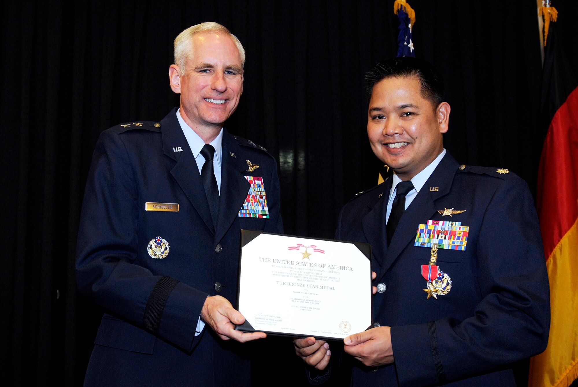 Maj. Gen. Mark Schissler, U.S. Air Forces in Europe director of the Plans, Programs and Analyses Directorate, presents the Bronze Star to Lt. Col. David Sumera, USAFE Plans, Program and Analyses chief of the Europe and Eurasia Branch, Feb. 14, 2011, at Ramstein Air Base, Germany. Colonel Sumera was deployed as the 380th Expeditionary Communications Squadron commander from July 12, 2009 to July 6, 2010. He received the Bronze Star for providing leadership to the second largest communications site in the U.S. Air Forces Central area of responsibility, generating 6,300 combat sorties directly supporting 3,500 events of troops-in-contact with the enemy. He ensured continuous communications were available throughout the AOR with providing support and connectivity to various aircraft. The Bronze Star is awarded to a person in any branch of the military service who, while serving in any capacity with the U.S. Armed Forces on or after Dec. 7, 1941, shall have distinguished himself by heroic or meritorious achievement or service, not involving participation in aerial flight, in connection with military operations against an armed enemy. It can also be awarded for heroism while serving with friendly forces engaged in combat against an opposing military. (U.S. Air Force photo by Tech. Sgt. Sarayuth Pinthong)