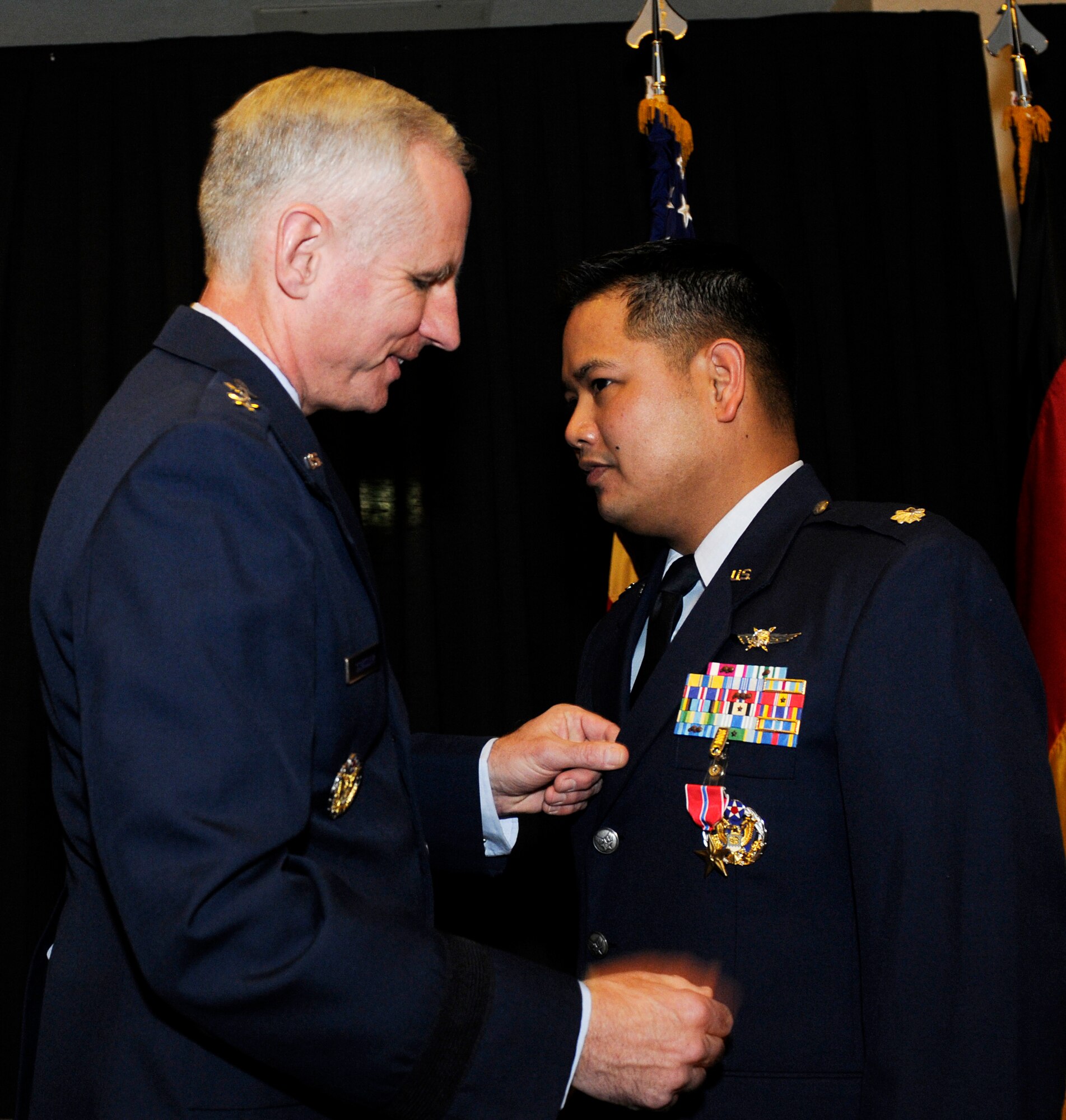 Maj. Gen. Mark Schissler, U.S. Air Forces in Europe director of the Plans, Programs and Analyses Directorate, presents the Bronze Star to Lt. Col. David Sumera, USAFE Plans, Program and Analyses chief of the Europe and Eurasia Branch, Feb. 14, 2011, at Ramstein Air Base, Germany. Colonel Sumera was deployed as the 380th Expeditionary Communications Squadron commander from July 12, 2009 to July 6, 2010. He received the Bronze Star for providing leadership to the second largest communications site in the U.S. Air Forces Central area of responsibility, generating 6,300 combat sorties directly supporting 3,500 events of troops-in-contact with the enemy. He ensured continuous communications were available throughout the AOR with providing support and connectivity to various aircraft. The Bronze Star is awarded to a person in any branch of the military service who, while serving in any capacity with the U.S. Armed Forces on or after Dec. 7, 1941, shall have distinguished himself by heroic or meritorious achievement or service, not involving participation in aerial flight, in connection with military operations against an armed enemy. It can also be awarded for heroism while serving with friendly forces engaged in combat against an opposing military. (U.S. Air Force photo by Tech. Sgt. Sarayuth Pinthong)
