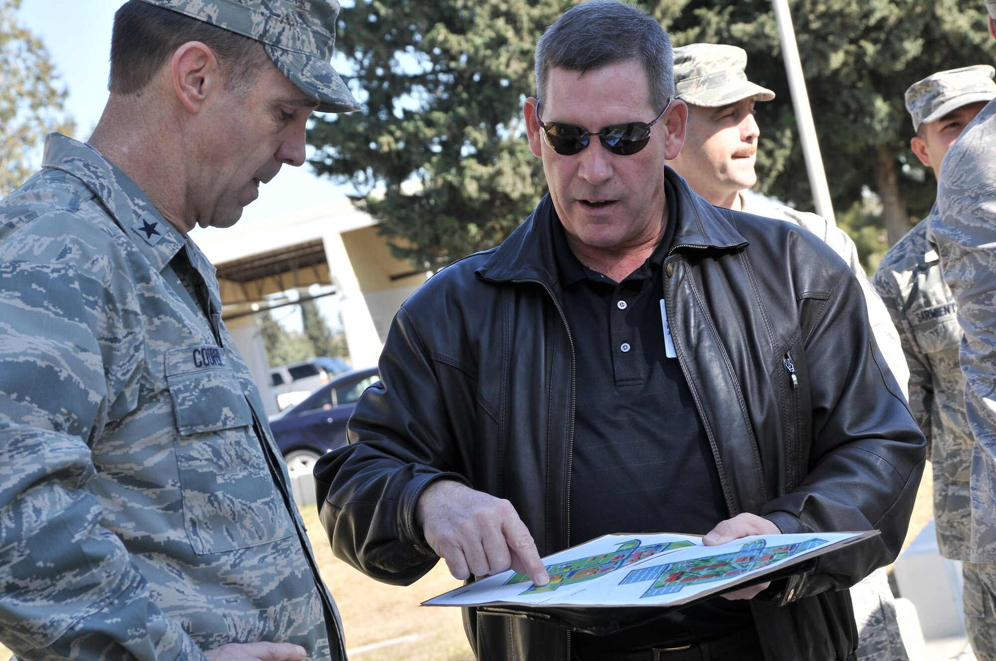Brig. Gen. John B. Cooper, the director of Logistics, Installations and Mission Support at Headquarters U.S. Air Forces in Europe, receives an overview of future building plans from James Brendlinger, of the  39th Civil Engineer Squadron, Feb. 11, 2011, at Incirlik Air Base, Turkey. General Cooper visited the base to tour the facilities and talk with Airmen about upcoming changes and how they will be affected, including their role in the new Expeditionary Combat Support System. The ECSS enhances warfighter support by transforming the way the Air Force performs its logistics business. (U.S. Air Force photo by Staff Sgt. Alex Montes/RELEASED)