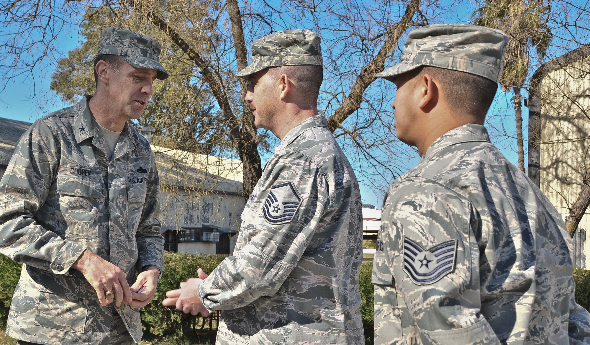 Brig. Gen. John B. Cooper, director of Logistics, Installations and Mission Support, at Headquarters U.S. Air Forces in Europe, coins Master Sgt. Michael Clapper and Technical Sgt. Arnold Sarmiento, of the 39th Civil Engineer Squadron, for exceptional work, Feb. 11, 2011, at Incirlik Air Base, Turkey. General Cooper visited the base to tour the facilities and talk with Airmen about upcoming changes and how they will be affected, including their role in the new Expeditionary Combat Support System. The ECSS enhances warfighter support by transforming the way the Air Force performs its logistics business. (U.S. Air Force photo by Staff Sgt. Alex Montes/RELEASED)