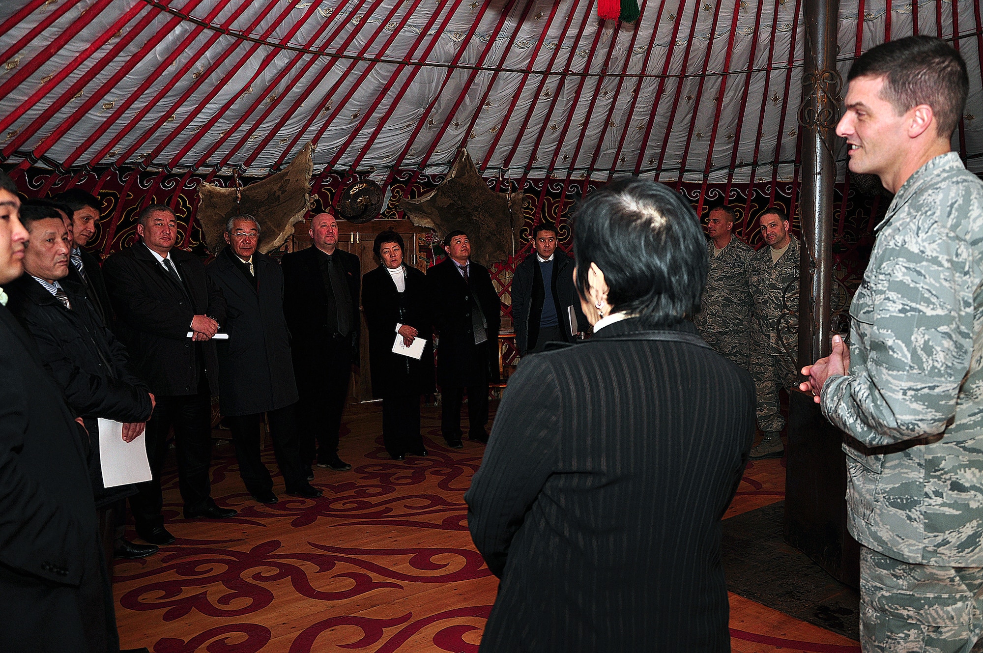 TRANSIT CENTER AT MANAS, Kyrgyzstan - Col. Dwight Sones, 376th Air Expeditionary Wing commander, welcomes Kyrgyz parliamentarians at a reception before a first-ever aerial refuel flight for members of the Kyrgyz Parliament 16 Feb.  Parliament members were taken on a KC-135 Stratotanker for a demonstration refueling mission with a C-17 Globemaster III over the skies of Kyrgyzstan. This demonstration of air power highlighted to the parliamentarians the role of the Aerial Refuel mission here, one of the Transit Center's four mission pillars. The other three pillars which were highlighted in the pre-flight briefing are Onward Movement, Airlift and Humanitarian Assistance. (U.S. Air Force photo/Master Sgt. Daniel Nathaniel) 