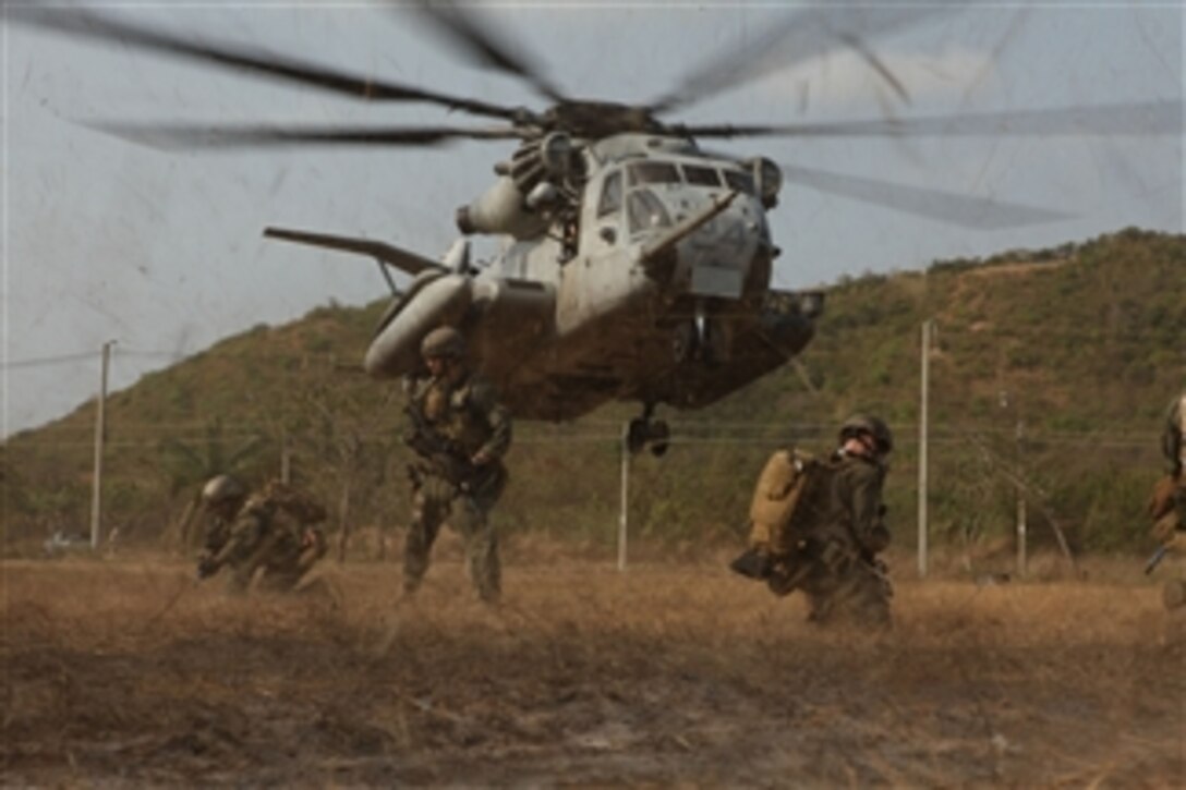 U.S. Marines with the Maritime Raid Force, 31st Marine Expeditionary Unit, 3rd Marine Expeditionary Brigade, provide security as a U.S. Marine Corps CH-53E Super Stallion helicopter lands during a mock raid conducted with Royal Thai Marines in Hat Yao, Kingdom of Thailand, in support of Exercise Cobra Gold 2011 on Feb. 16, 2011.  For three decades Thailand has hosted Cobra Gold, one of the largest land-based, joint, combined military training exercises in the world.  
