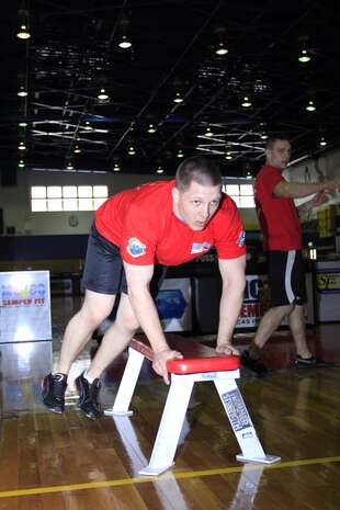 Cpl. Darren Guffey, Marine Wing Support Squadron 171 competitor, busts out bench leaps at the Strength and Endurance Commander’s Cup challenge at IronWorks Gym here Feb. 18. MWSS-171 took first place with an accumulated 1,364 repetitions.