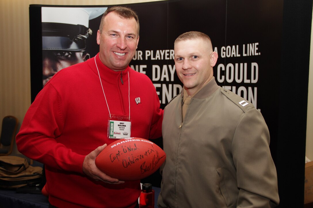 Recruiting Station Twin Cities Executive Officer Capt. Douglas Woodcock, 34, from Columbia, Mo., acquires an autograph from Badgers head football coach Bret Bielema for one of his fellow Marines who graduated from the University of Wisconsin. More than 1,000 football enthusiasts from across the Midwest attended the conference. For more photos of the event, visit the RS Twin Cities fan page at www.facebook.com/rstwincities.