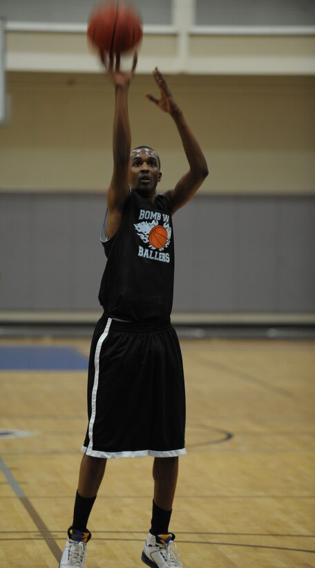 DYESS AIR FORCE BASE, Texas—Gregory Showell, Bomb Wing Ballers guard, shoots a basketball Feb. 16 during an intramural basketball game here. The 7th Bomb Wing intramural basketball team competed against the 7th Civil Engineer team in a 40-minute basketball game. The final score was 51-50 with the 7 BW taking the win.  By participating in intramurals Dyess Airmen come together and learn how to work better as a team, while boosting morale throughout the base. The basketball season started in January and lasts through April. Other intramural sports include: football, softball, soccer, golf, racquetball and volleyball. For more information on intramural sports, call the fitness center at (325) 696-4306. (U.S Air Force photo/ Airman 1st Class Shannon Hall)