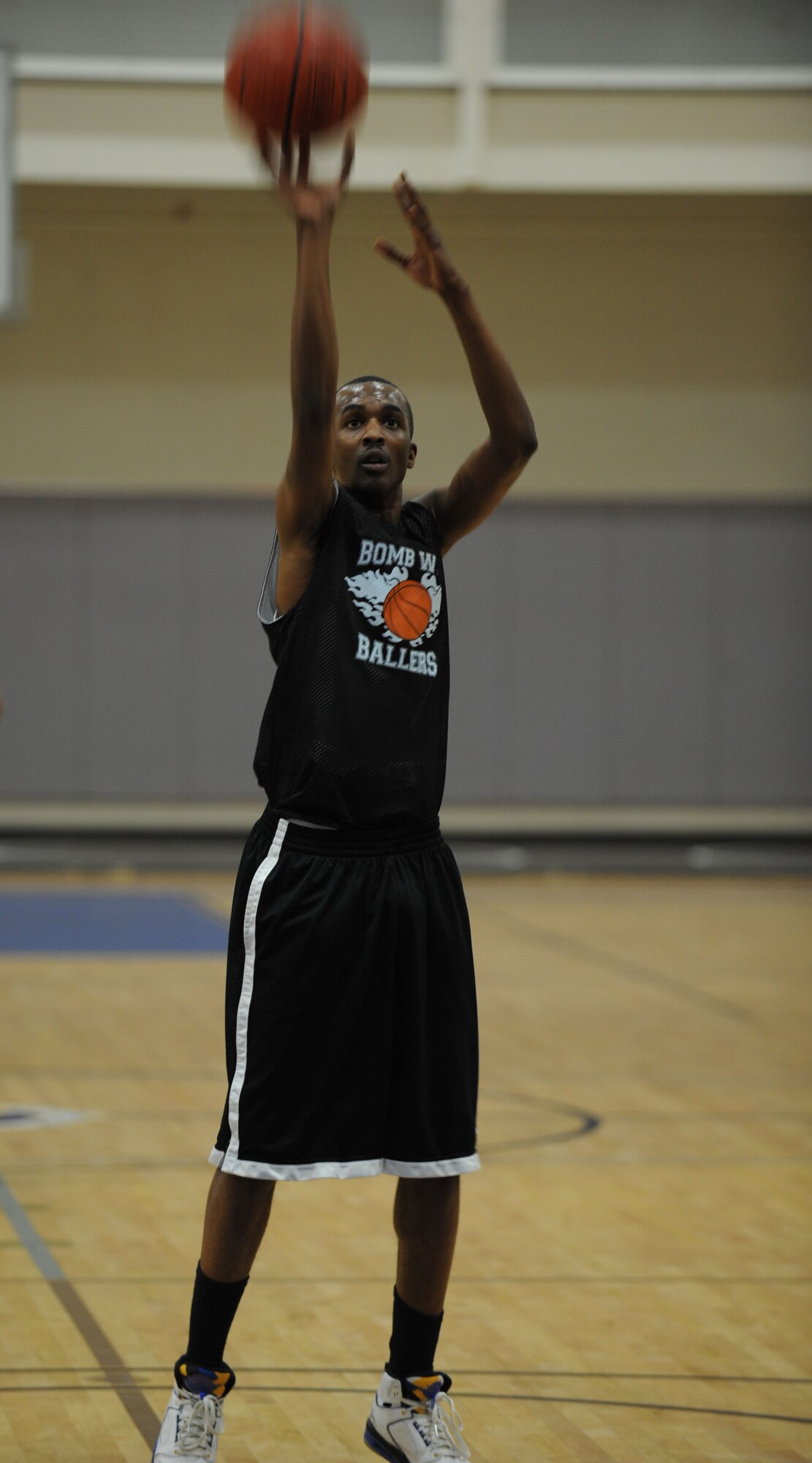 DYESS AIR FORCE BASE, Texas—Gregory Showell, Bomb Wing Ballers guard, shoots a basketball Feb. 16 during an intramural basketball game here. The 7th Bomb Wing intramural basketball team competed against the 7th Civil Engineer team in a 40-minute basketball game. The final score was 51-50 with the 7 BW taking the win.  By participating in intramurals Dyess Airmen come together and learn how to work better as a team, while boosting morale throughout the base. The basketball season started in January and lasts through April. Other intramural sports include: football, softball, soccer, golf, racquetball and volleyball. For more information on intramural sports, call the fitness center at (325) 696-4306. (U.S Air Force photo/ Airman 1st Class Shannon Hall)