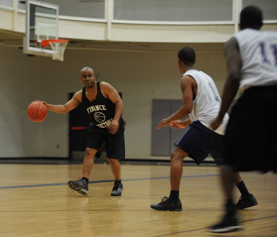 DYESS AIR FORCE BASE, Texas—Trevor Williams, Bomb Wing Ballers guard, dribbles a basketball Feb. 16 during an intramural basketball game here. The 7th Bomb Wing intramural basketball team competed against the 7th Civil Engineer team in a 40-minute basketball game. The final score was 51-50 with the 7 BW taking the win. By participating in intramurals, Dyess Airmen come together and learn how to work better as a team, while boosting morale throughout the base. The basketball season started in January and lasts through April. Other intramural sports include: football, softball, soccer, golf, racquetball and volleyball. For more information on intramural sports, call the fitness center at (325) 696-4306. (U.S Air Force photo/ Airman 1st Class Shannon Hall)