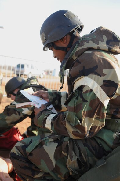 DYESS AIR FORCE BASE, Texas—Airman 1st Class Robert Hicks, 7th Bomb Wing Public Affairs, looks through his Airman’s Manual Feb. 17 during an ability to survive and operate training competition here. To help prepare for the upcoming Operational Readiness Exercise, Dyess held a competition between squadrons to test their ability to operate and survive during war time. The competition consisted of different obstacles such as self-aid and buddy care, vehicle decontamination, self-decontamination and answering a variety of questions. To succeed, Airmen had to work together and finish each obstacle thoroughly and quickly. (U.S Air Force photo/ Airman 1st Class Shannon Hall)