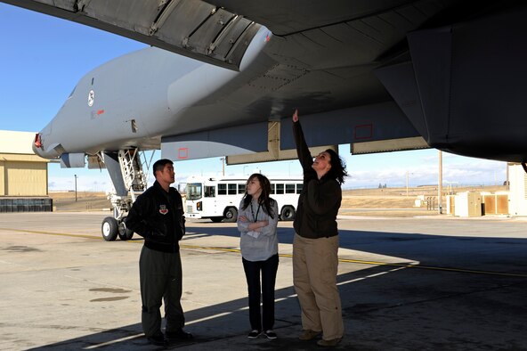 Capt. Will Louie, 34th Bomb Squadron weapon systems officer, describes the capabilities of the B-1B Lancer to two high school students on Ellsworth Air Force Base, S.D., Feb. 17, 2011.  The students are participating in the Junior Leadership Rapid City program. (U.S. Air Force photo/Staff Sgt. Marc I. Lane)