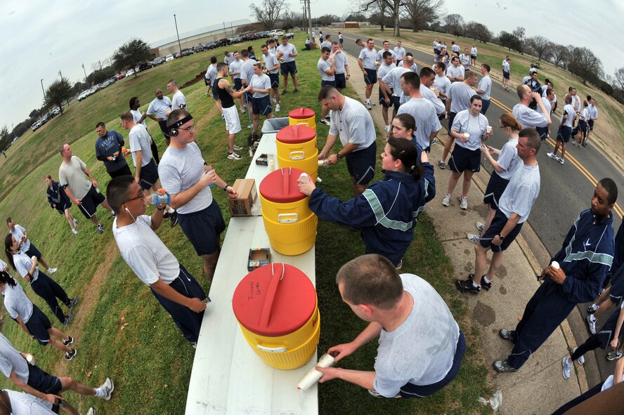 Participants of the "Bring Your Valentine" 5k Run hydrate and socialize after the event on Barksdale Air Force Base, La., Feb. 18. The Fitness Center will be hosting a 5k run for St. Patrick's Day where all participants will be encouraged to wear green. (U.S. Air Force photo/Airman 1st Class Micaiah Anthony)(Released) 