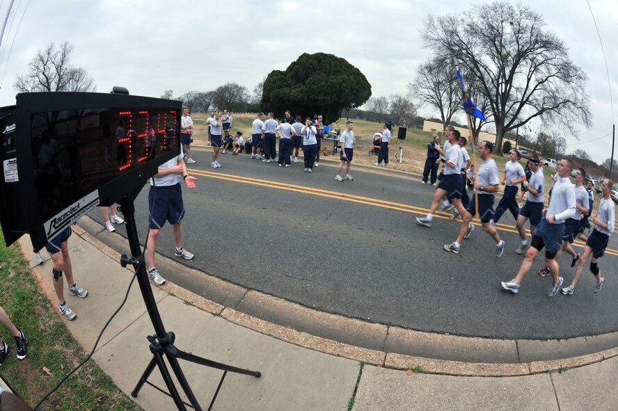 Members of the 26th Operational Weather Squadron cross the finish line during the "Bring Your Valentine" 5k Run on Barksdale Air Force Base, La., Feb. 18. The 26 OWS carried their guidon during the entire event. Three Airmen where given the honor of carrying the guidon during the run. (U.S. Air Force photo/Airman 1st Class Micaiah Anthony)(Released)