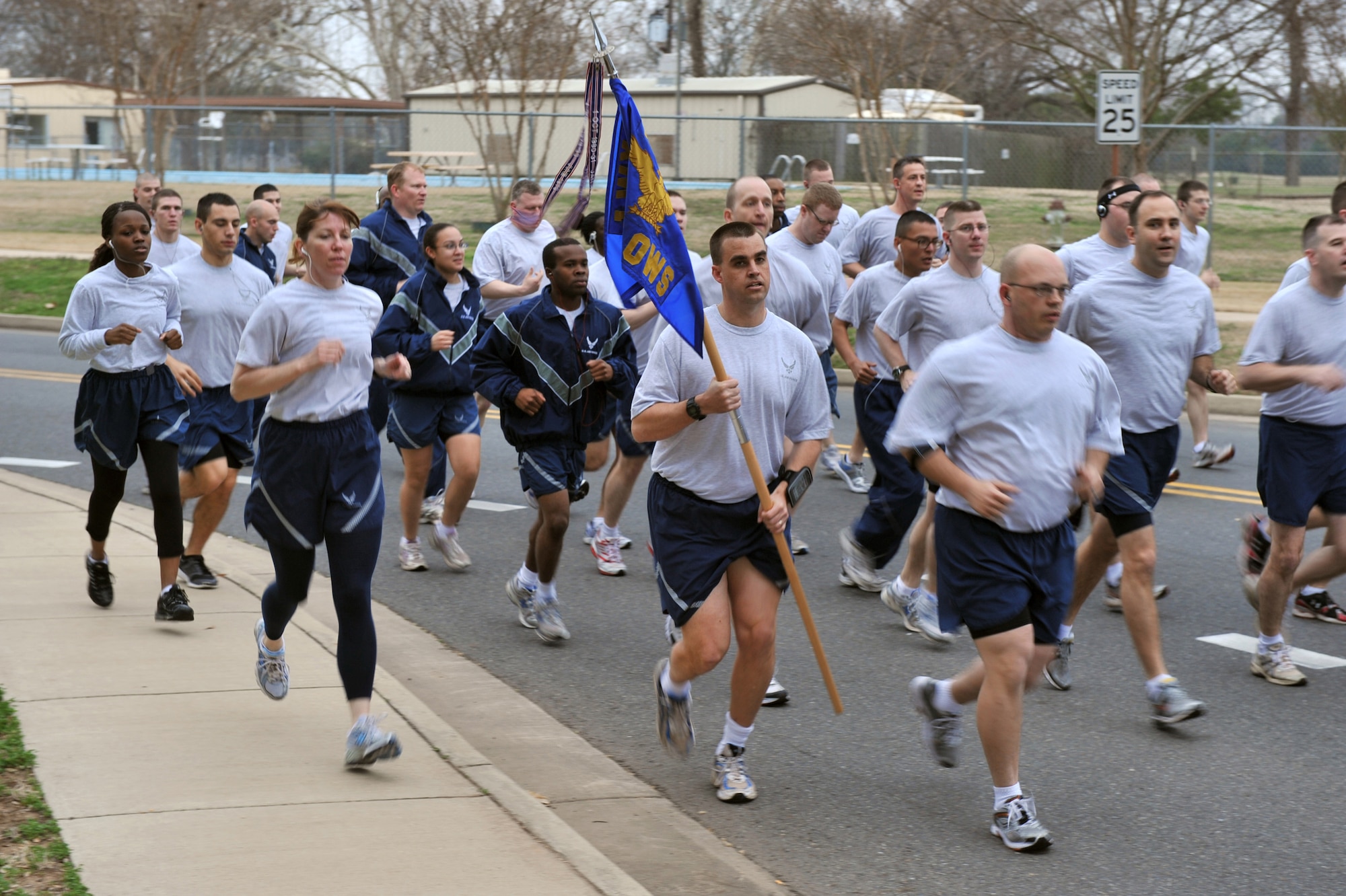 Master Sgt. Todd Preimesberger, 26th Operational Weather Squadron, carries a guidon during the "Bring Your Valentine" 5k Run on Rickenbacker Avenue on Barksdale Air Force Base, La., Feb. 18. Guidons are used in all branches of the United States military to distinguish units and boost morale.  (U.S. Air Force photo/Airman 1st Class Micaiah Anthony)(Released)