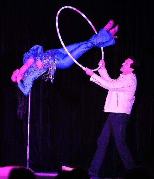 DYESS AIR FORCE BASE, Texas—Tim (right) and Tina Kole perform a balancing magic trick Feb. 17 at the Heritage Club here. André Kole, Tim’s father, is a world renowned illusionist and investigator of the supernatural, and has been to 79 countries demonstrating his talent. He is most recognized for his demonstration of walking on water.  (U.S Air Force photo/Airman 1st Class Shannon Hall)