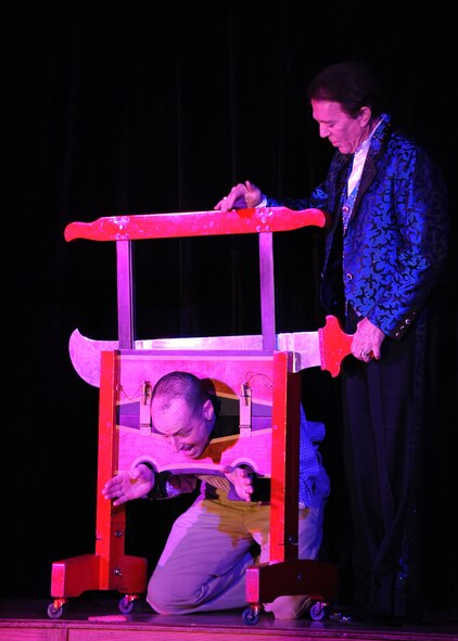 DYESS AIR FORCE BASE, Texas—André Kole, (right) world renowned illusionist and investigator of the supernatural, prepares to cut off the head of Col. David Béen, 7th Bomb Wing commander,  Feb. 17 during a magic show at the Heritage Club here. Mr. Kole has been to 79 countries demonstrating his talent, and is most recognized for his demonstration of walking on water. (U.S Air Force photo/Airman 1st Class Shannon Hall) 