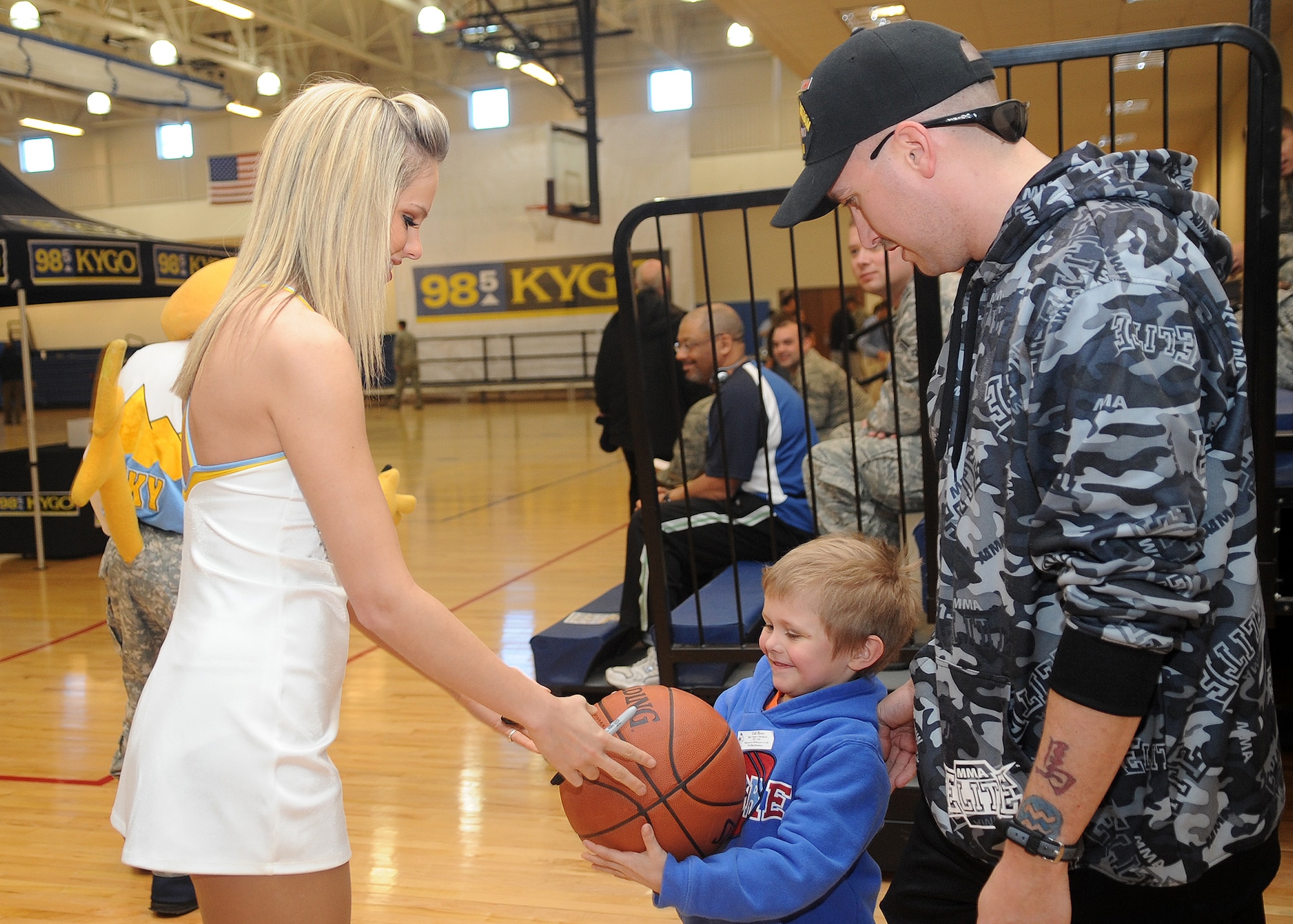 Buckley Air Force Base, Colo.- Members of the Denver Nuggets dance team signed memorabilia for military members and their families  February 17, 2011. The local radio station, 98.5 KYGO and the Denver Nuggets came together to host the military appreciation day event. ( U.S. Air Force Photo by Airman 1st Class Marcy Glass )


