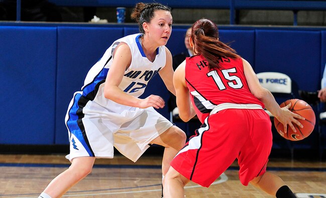 Air Force's Megan Muniz defends against UNLV's Erica Helms during the Falcons' game against the Rebels at the Air Force Academy's Clune Arena Feb. 16, 2011. Muniz, a sophomore and native of Rio Rancho, N.M., had nine points and two rebounds in the Falcons' 91-87 victory. (U.S. Air Force photo/Bill Evans)