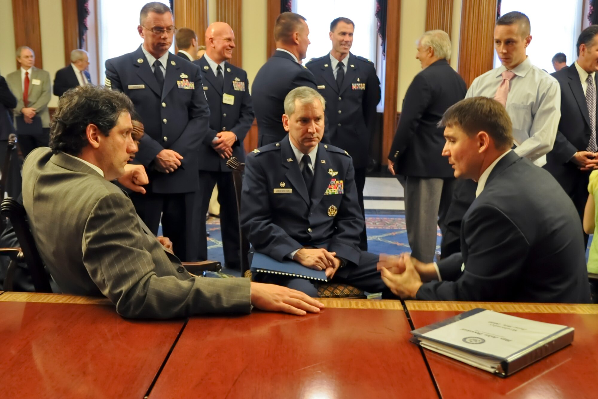 Congressman (and Air Force Reserve Maj.) John Boccieri (right, seated) talks with Col. Fritz Linsenmeyer, commander of the 910th Airlift Wing, (center, seated) and Congressman Tim Ryan (right, seated) about the 910th Airlift Wing’s aerial spray mission in the Rayburn Room of the Capitol Building, Washington, D.C., June 9, 2010. The congressmen spoke with Colonel Linsenmeyer and his small team of Youngstown Air Reserve Station Citizen Airmen about the unit’s operations in the Gulf of Mexico during the aftermath of the explosion and sinking of the Deepwater Horizon oil-drilling platform. The group also talked about the overall capabilities of the DoD’s only large-area fixed-wing aerial spray unit. 