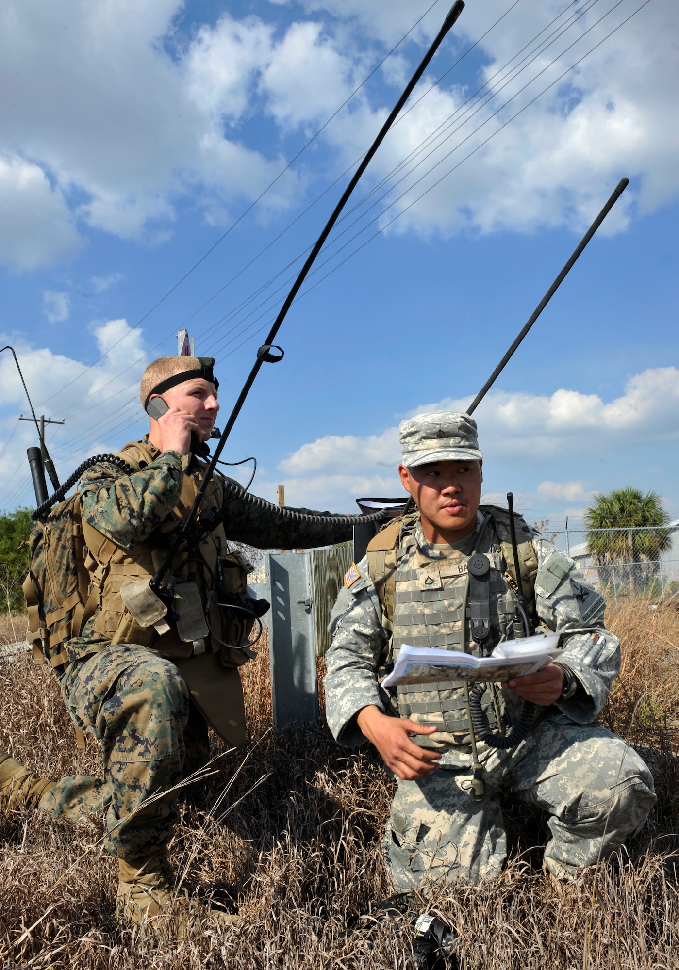 AVON PARK, Fla.—Marine Corps Lance Cpl. James Swaffield, 1st Battalion 11th Marines and Army Pfc. Jayson Back, 2nd Battalion 5th Infantry Regiment joint fires observers, radio to the aircraft and the joint terminal attack controller on what they see at their location during joint exercise ATLANTIC STRIKE 11-01 Feb. 16. The two members took turns radioing describing what they saw at their location and all the information needed to drop bombs on target. (U.S. Air Force photo/Airman 1st Class Nicholas Benroth)(RELEASED)
