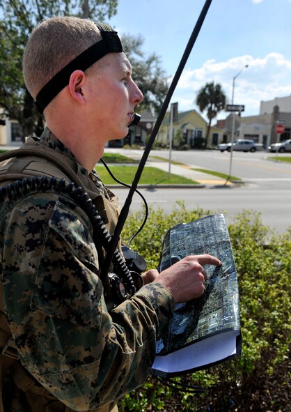 AVON PARK, Fla.-- Marine Corps Lance Cpl. James Swaffield, 1st Battalion, 11th Marines joint fires observer, traces his finger across the map as he moves toward their objective during joint exercise ATLANTIC STRIKE 11-01 Feb. 16. During the urban tactics scenario, the JFOs observed targets and relayed critical information to the joint terminal attack controller and the aircraft. (U.S. Air Force photo/Airman 1st Class Nicholas Benroth)(RELEASED