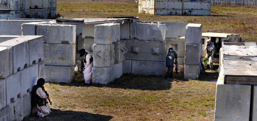 AVON PARK, Fla.-- Opposing forces take cover in a makeshift building as members of the 823rd Base Defense Squadron from Moody Air Force Base, Ga. advance on their position during joint exercise ATLANTIC STRIKE 11-01 Feb. 16.
This was one part of an 11-day exercise to train joint terminal attack controllers on the practice of working with ground forces to call in close air support. (U.S. Air Force photo/Airman 1st Class Nicholas Benroth)(RELEASED)