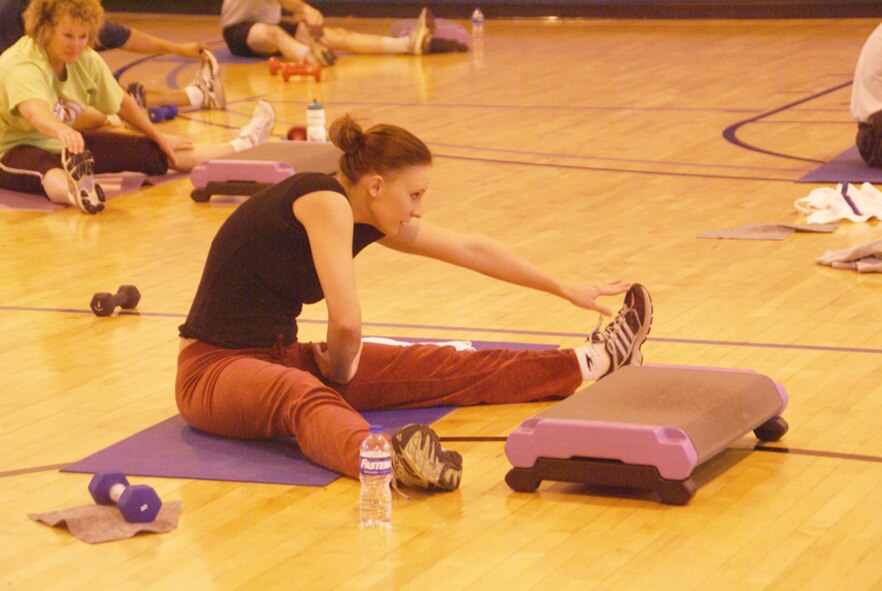 Sara Rozell, AEDC financial management specialist, stretches after a vigorous hour-long boot camp class at the Fitness Center. (Photo by Philip Lorenz III)