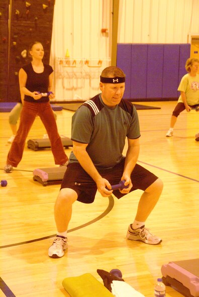 Col. Robert Bender, chief of AEDC’s Mission Support Division, lifts an 8-pound hand weight during the boot camp class at the Fitness Center. He advised others to pace themselves during a class that mixes traditional callisthenic and body weight exercises with interval training and strength training. (Photo by Philip Lorenz III)
