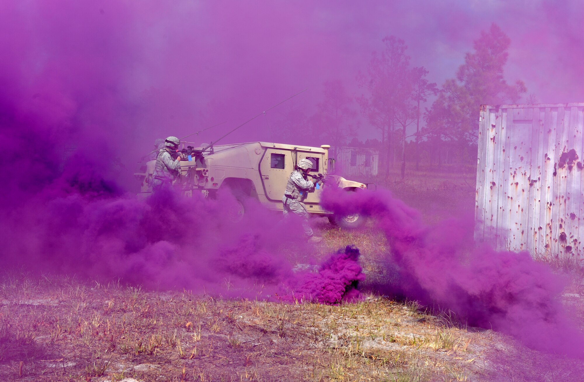 AVON PARK, Fla.-- Members of the 823rd Base Defense Squadron from Moody Air Force Base, Ga., travel behind a cloud of purple smoke during joint exercise ATLANTIC STRIKE 11-01 Feb. 16. The 823rd BDS invaded a mock village with support from a joint terminal attack controller calling in airstrikes during the exercise. (U.S. Air Force photo/Airman 1st Class Benjamin Wiseman)(RELEASED)