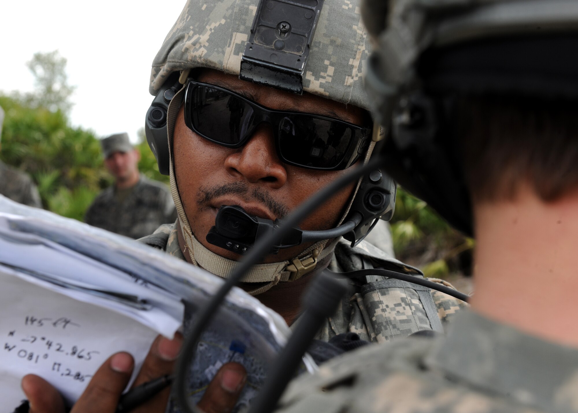 AVON PARK, Fla.-- Staff Sgt. Ross Walker, 7th Air Support Operations Squadron joint terminal attack controller, Fort Bliss, Texas,  gives final coordinates of a target as a B-52 Stratofortress aircraft flies overhead during joint exercise ATLANTIC STRIKE 11-01 Feb. 16. During the exercise, JTACs had to call in air strikes over forward ground forces with complete accuracy to ensure a successful mission. (U.S. Air Force photo/Airman 1st Class Benjamin Wiseman)(RELEASED)