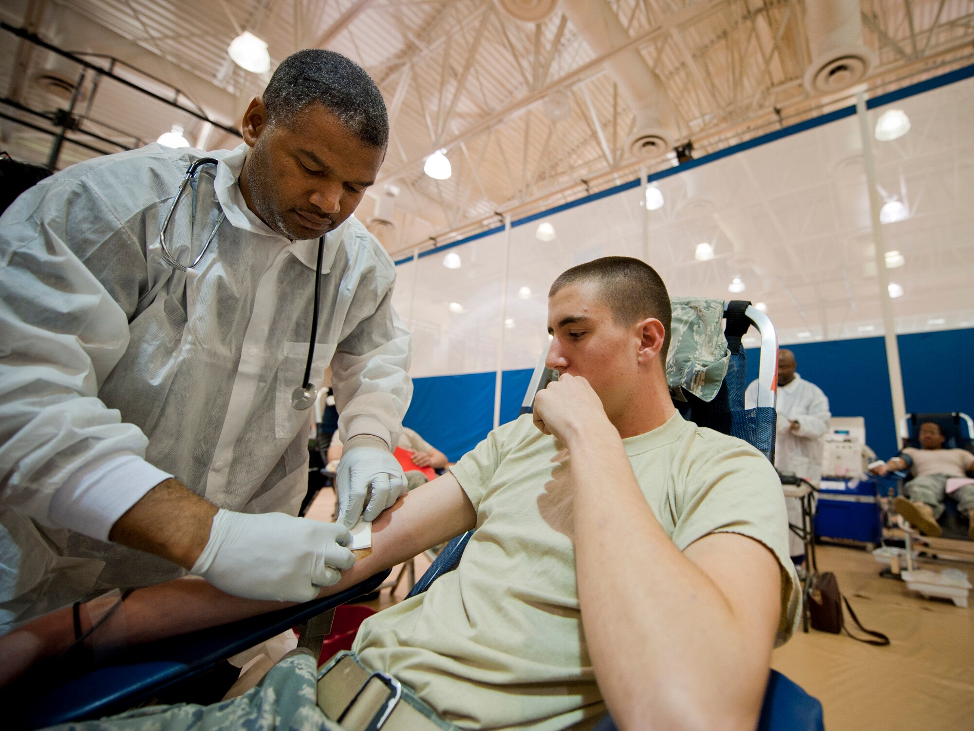 MOODY AIR FORCE BASE, Ga. -- Joe Cladd, American Red Cross phlebotomist, prepares to draw blood from Senior Airman Jacob Hensley, 822nd Base Defense Squadron fire team member, Feb. 17 during a blood drive at the Freedom I Fitness Center. Airman Hensley was slightly nervous since it was his first time donating blood. (U.S. Air Force photo/Staff Sgt. Jamal D. Sutter)(RELEASED)